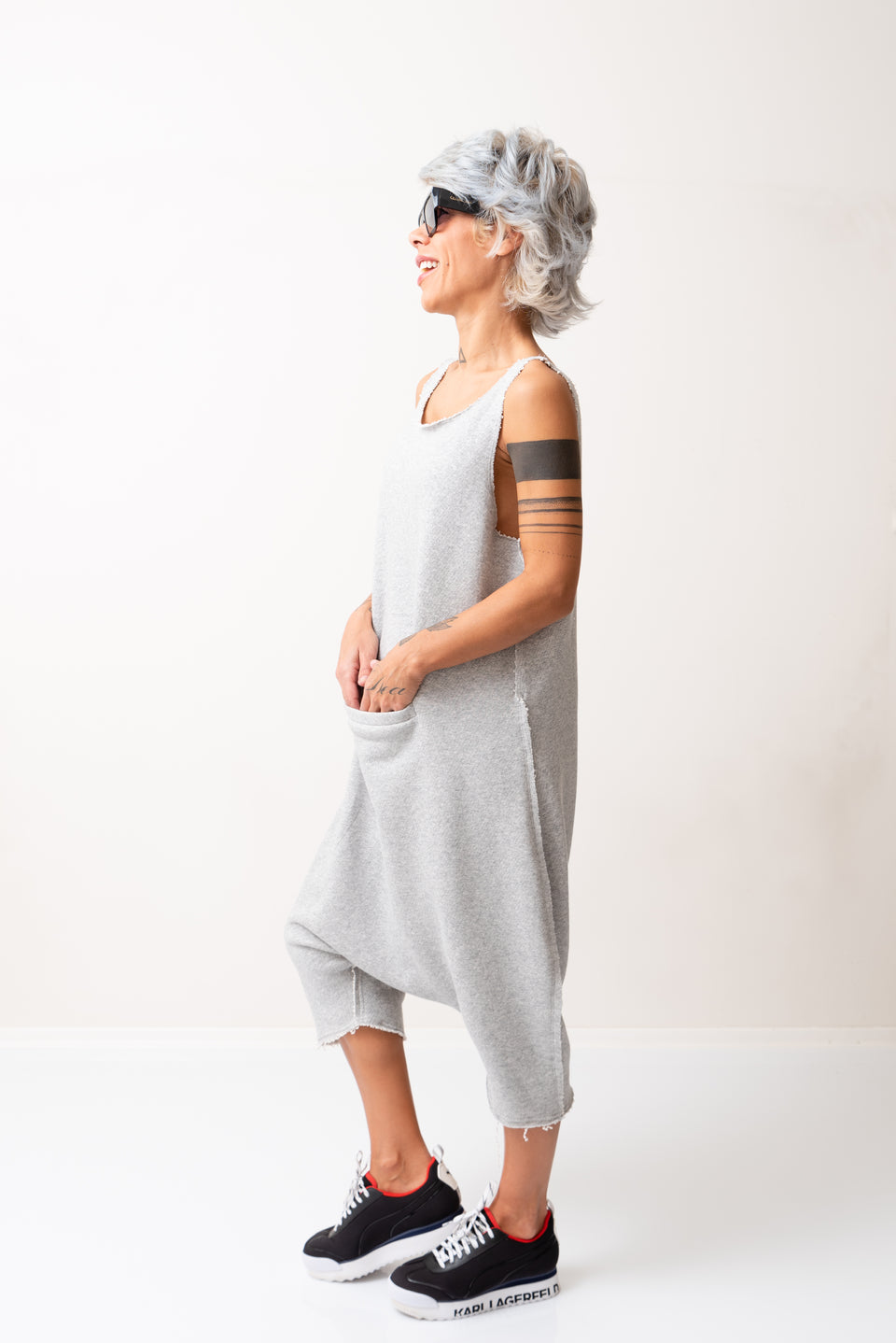 GREY OVERSIZED SLEEVELESS JUMPSUIT PAIRED WITH A TOP WITH LONG SLEEVES
