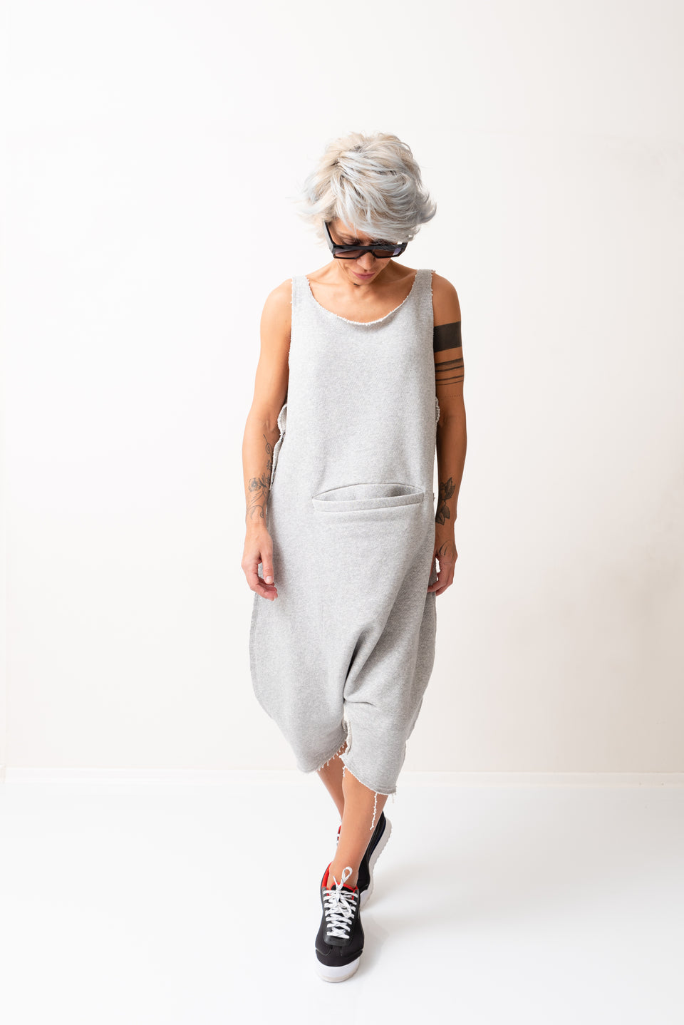 GREY OVERSIZED SLEEVELESS JUMPSUIT PAIRED WITH A TOP WITH LONG SLEEVES
